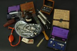 A collection of 19th and 20th century medical equipment and instruments, including syringes, a
