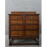 An early 20th century antique style oak chest of drawers, with a gallery back over four long