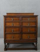 An early 20th century antique style oak chest of drawers, with a gallery back over four long