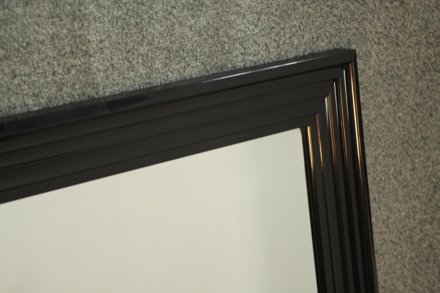 A contemporary ebonised mirror, with a rectangular mirrored plate in a moulded frame. H.107 W.76cm - Image 4 of 6