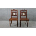 A pair of Victorian walnut Aesthetic movement hall chairs, the back set with a single tile, possibly