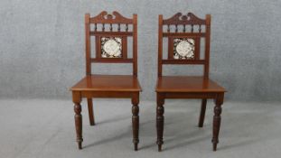 A pair of Victorian walnut Aesthetic movement hall chairs, the back set with a single tile, possibly