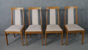 A set of four mid to late 20th century dining chairs, upholstered to the splat back and seat with