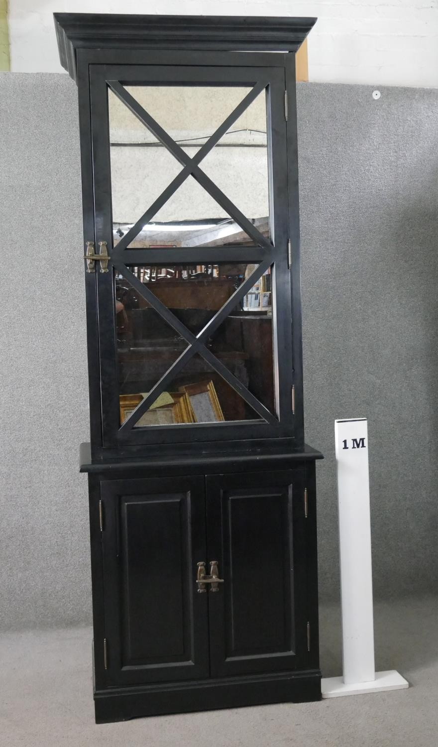 A contemporary ebonised tall cabinet, with a moulded cornice over a mirrored door, over two cupboard - Image 3 of 9