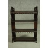 A late Victorian rustic hanging bookshelf, with shaped and pierced sides, the shelves with an