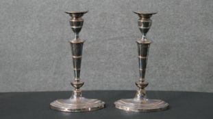 A pair of early 20th century silver plated candlesticks with weighted bottoms. H.29 W.17cm