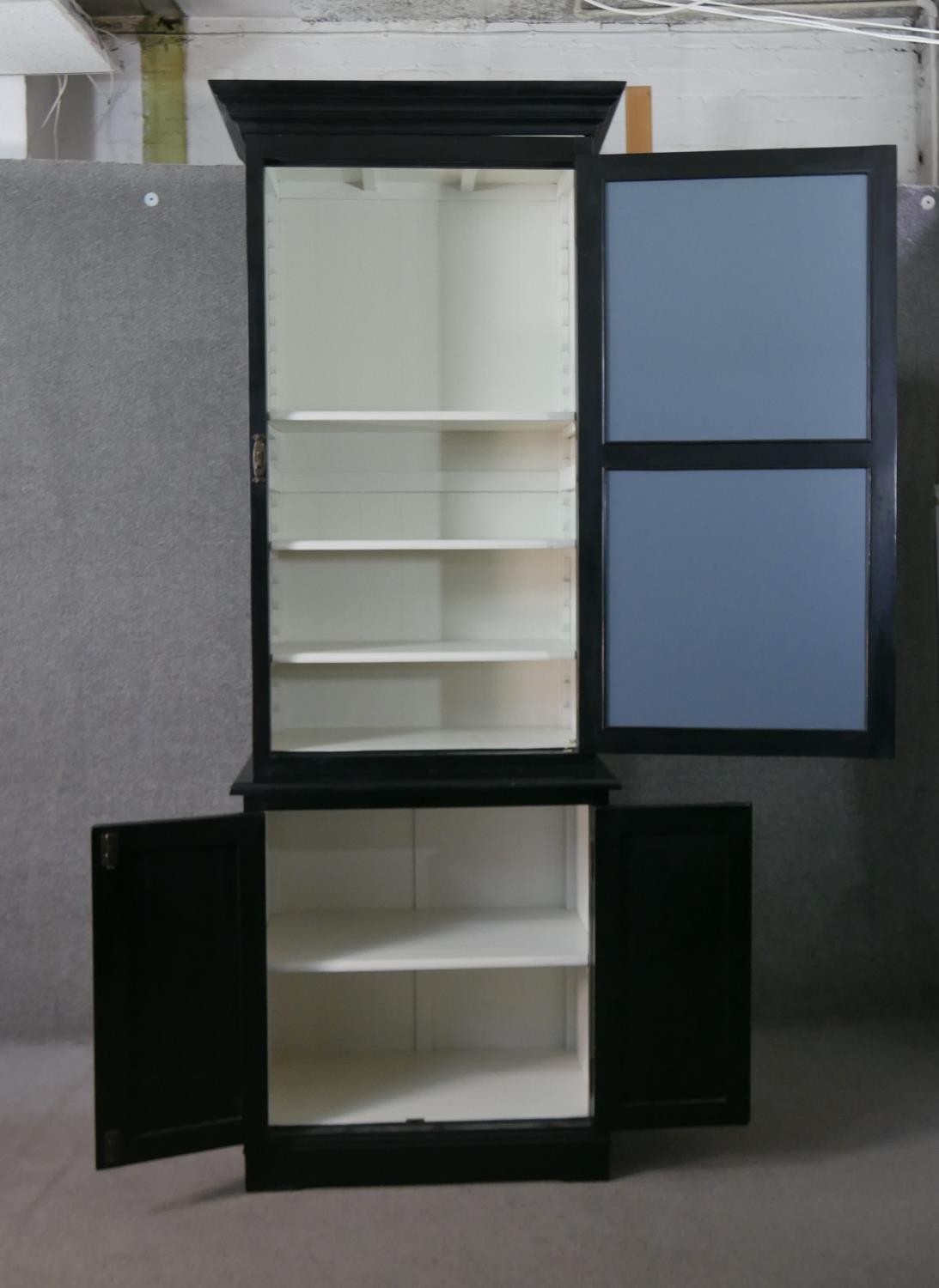 A contemporary ebonised tall cabinet, with a moulded cornice over a mirrored door, over two cupboard - Image 6 of 9