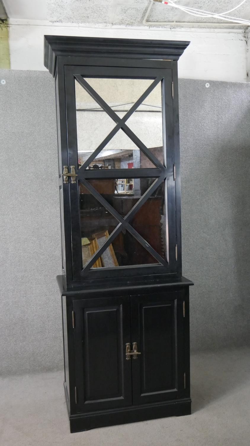 A contemporary ebonised tall cabinet, with a moulded cornice over a mirrored door, over two cupboard - Image 2 of 9