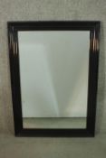 A contemporary ebonised mirror, with a rectangular mirrored plate in a moulded frame. H.107 W.76cm