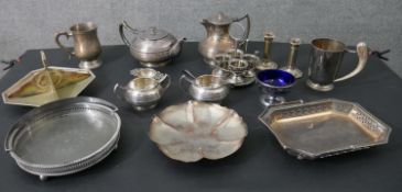 A large collection of silver plate, including a pair of candlesticks, a four piece tea set with