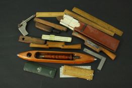A collection of woodworking tools, including rules, planes and other measuring implements. L.42 (
