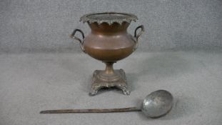 A copper twin handled urn on foliate form base along with a 19th century hammered copper jam