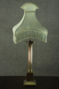 A 20th century brass table lamp, in the form of a Corinthian column, on a square section step down