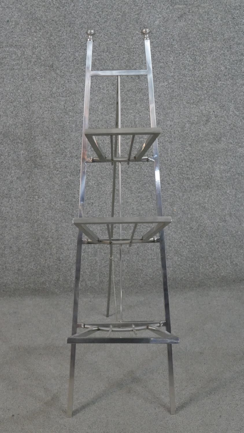 A chrome ladder design folding magazine rack. H.90 W.24 D.54cm