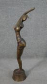 An Art Deco style brass sculpture of a stylised dancer on a pedestal base. in H.58 W.22 D.11cm