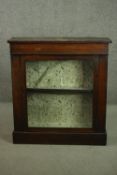 A Victorian rosewood pier cabinet, the single glazed door enclosing a single shelf, on a plinth