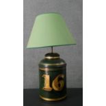 A toleware enamelled tin tea cannister, converted to a table lamp, with a green shade, the green