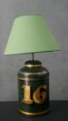 A toleware enamelled tin tea cannister, converted to a table lamp, with a green shade, the green