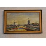 A gilt framed oil on canvas, Windmills and Dutch Bulb Fields landscape, signed A. Martens. H.31 W.