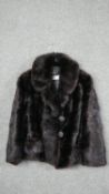 A ladies vintage short brown mink coat, retailed by Morgans, black silk lining embroidered with