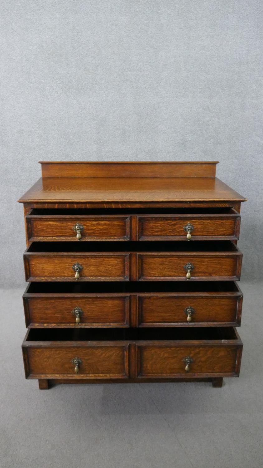 An early 20th century antique style oak chest of drawers, with a gallery back over four long - Image 5 of 7