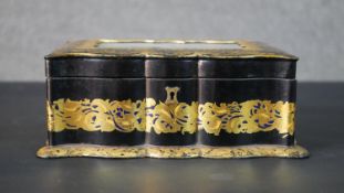 A Victorian papier-mâché sewing box, the lid with central rectangular reverse glass panel