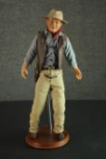 A Franklin Heirloom John Wayne doll and stand, porcelain and cloth, 1990. H.54cm.