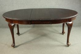 A Victorian mahogany extending wind-out dining table, of oval form, with an additional lead and a