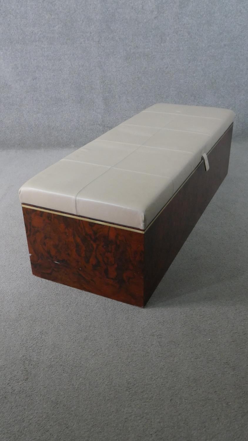 A figured walnut Ottoman, of slender rectangular form, with a white upholstered leather cushion lid, - Image 2 of 6