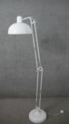 A white powder coated floor standing anglepoise reading lamp, on a circular base. H.177cm