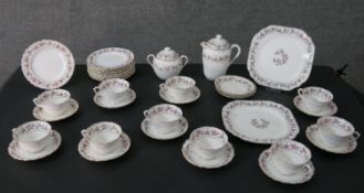 An early 20th century ten setting part hand painted fine china tea set, decorated with orange