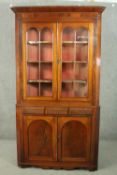 A George III mahogany corner display cabinet, with two glazed doors, over three short drawers, above