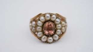 A Georgian pearl and topaz yellow metal cluster ring. Set to centre with an oval foil backed peach