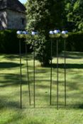 A set of six stainless steel plant stake garden sculptures, with poppy floral shape tops. H.140cm