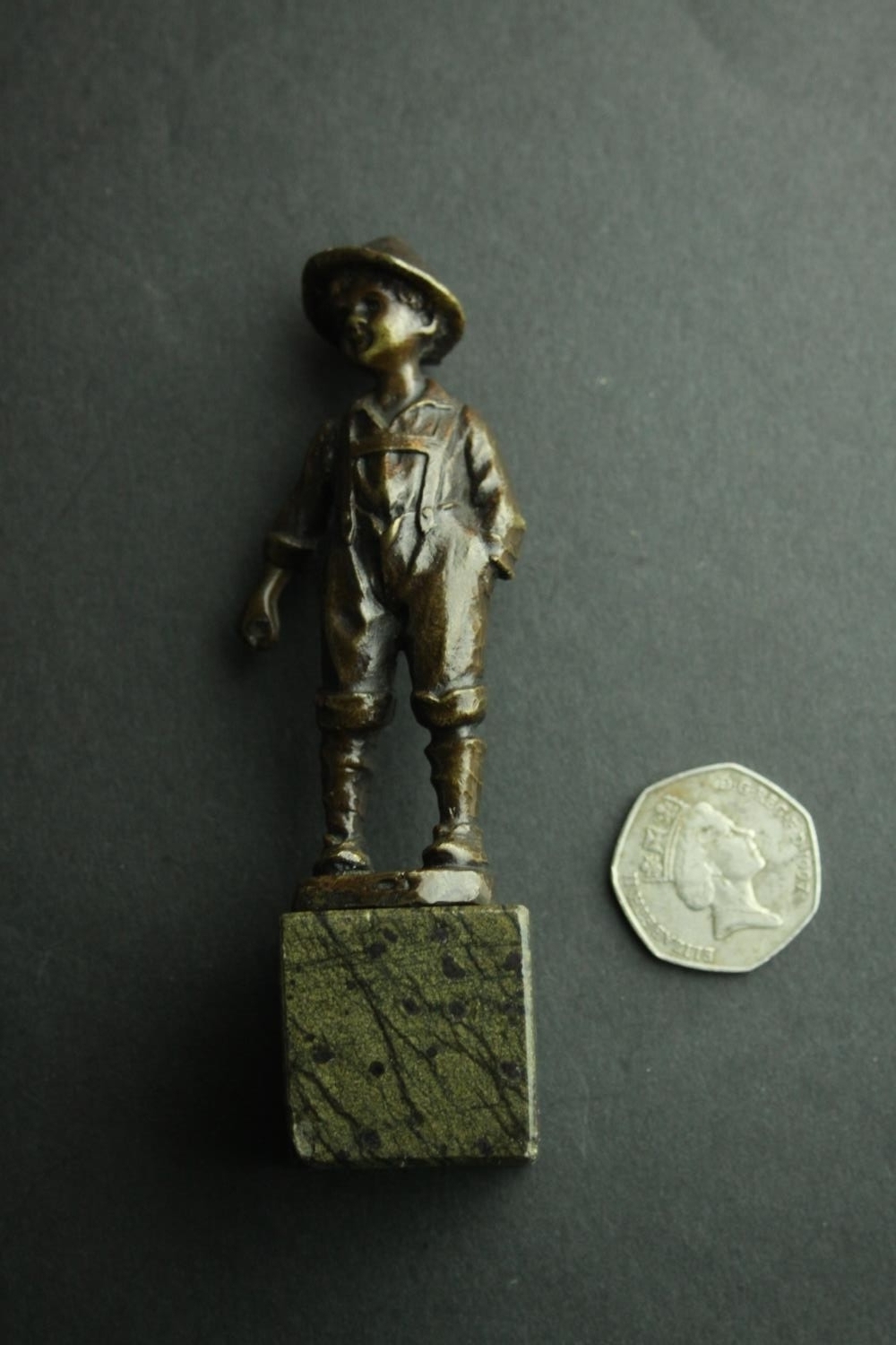 A bronze figure of an Austrian boy mounted on a serpentine marble base. H.13cm. - Image 2 of 5