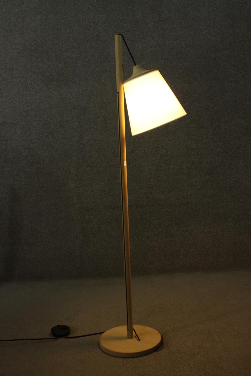 A contemporary light oak standard lamp, the white shade hanging from a cylindrical stem, on a - Image 4 of 7
