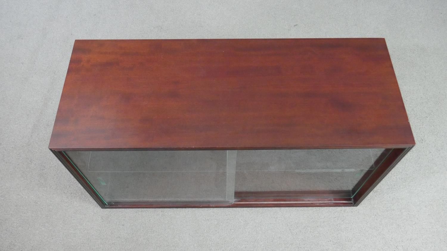 A circa 1970s fruitwood side cabinet, of rectangular form with two glass sliding doors, enclosing an - Image 2 of 5