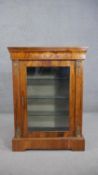 A Victorian marquetry inlaid figured walnut pier cabinet, with a single glazed door, enclosing glass