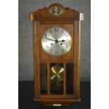 An oak regulator wall clock, the circular silvered dial with Arabic numerals, bearing Thomas Lloyd