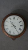 A late 19th / early 20th century circular mahogany framed wall clock, the enamelled dial with