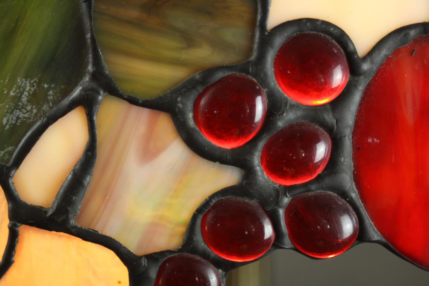 A Tiffany style table lamp, with a stained glass shade depicting fruit, the bronzed brass base - Image 9 of 10