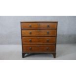 A 19th century mahogany chest of four long graduated drawers, with lion mask ring handles, on