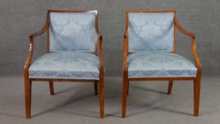 A pair of late 20th century fruitwood open armchairs, the back and seat upholstered in sky blue