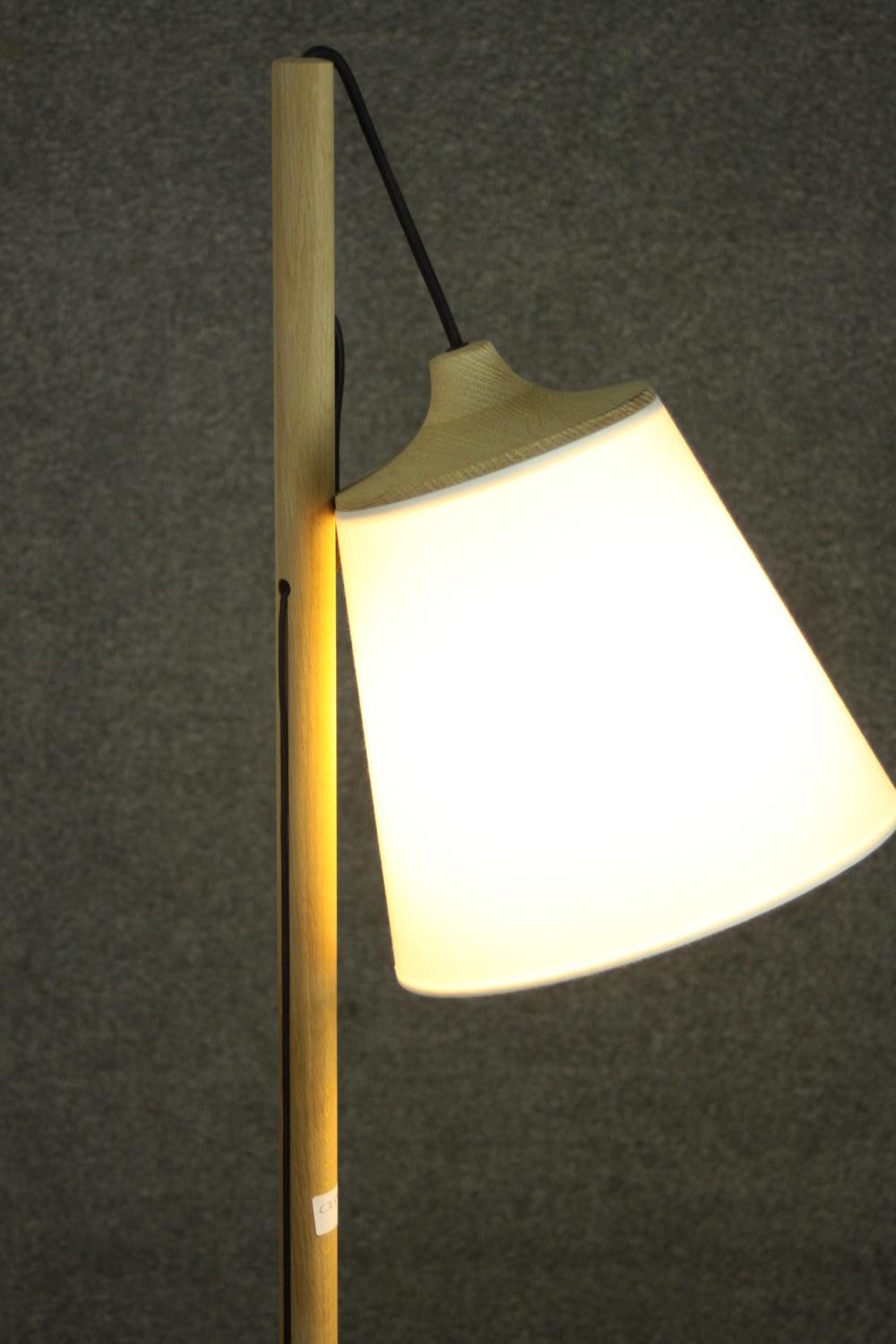 A contemporary light oak standard lamp, the white shade hanging from a cylindrical stem, on a - Image 5 of 7