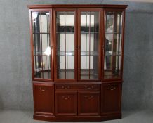 A G-Plan mahogany display cabinet, with four glazed doors, enclosing glass shelves, with a