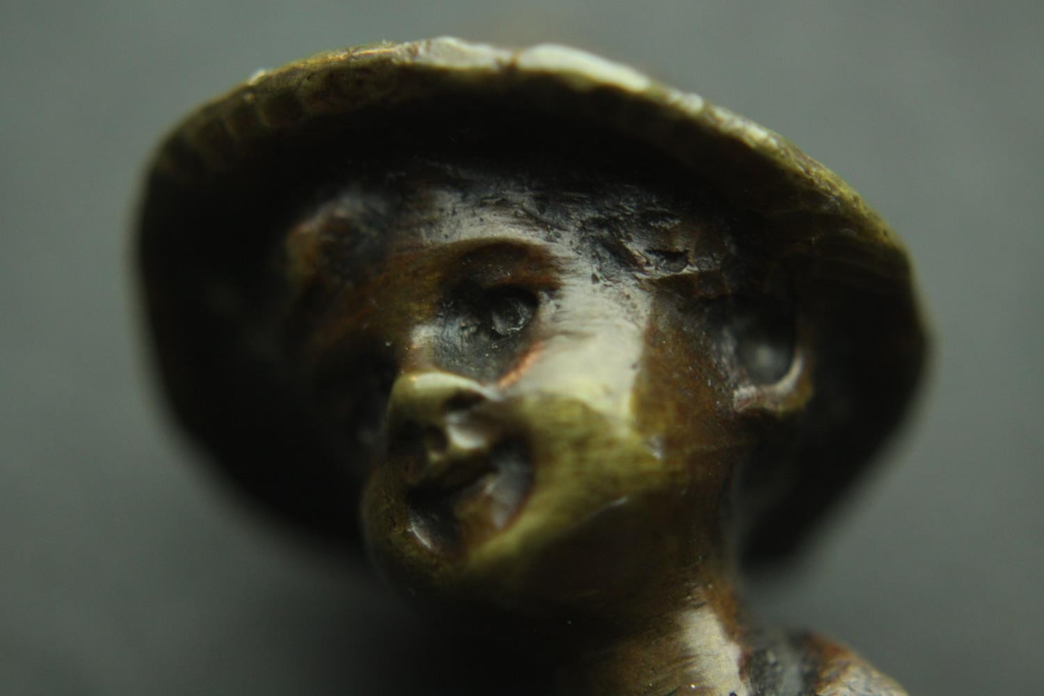 A bronze figure of an Austrian boy mounted on a serpentine marble base. H.13cm. - Image 3 of 5