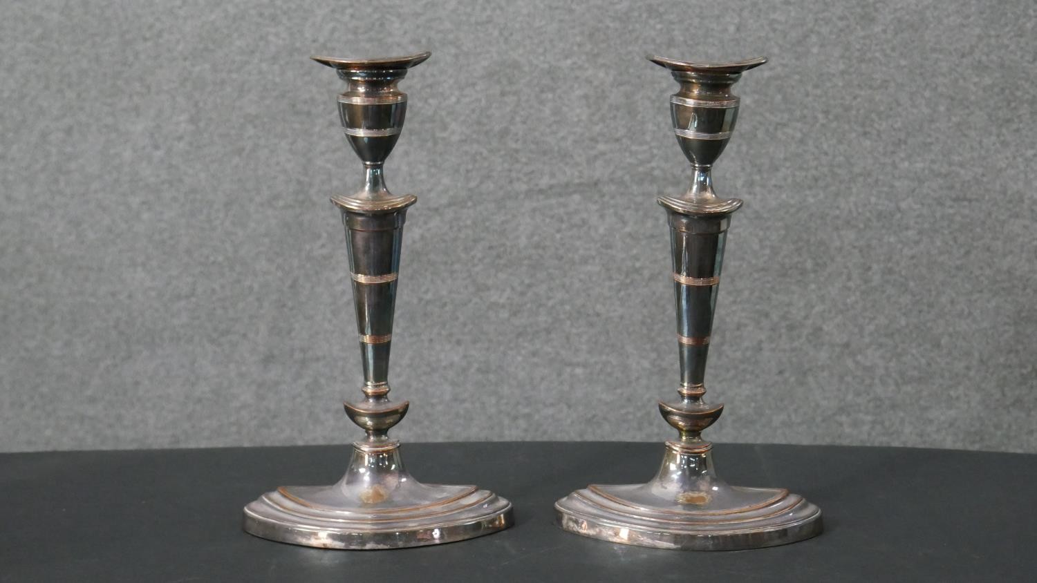 A pair of early 20th century silver plated candlesticks with weighted bottoms. H.29 W.17cm
