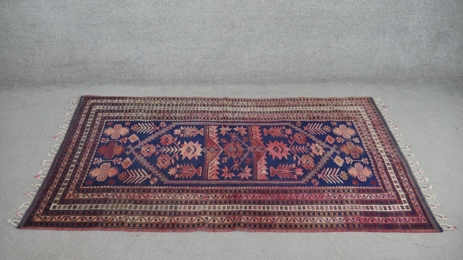 A handmade Turkish Yagcibedir rug, on a blue ground. L.108 W.118cm.