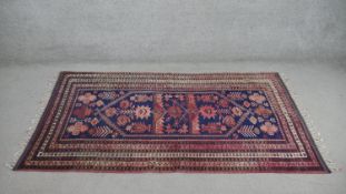 A handmade Turkish Yagcibedir rug, on a blue ground. L.108 W.118cm.
