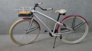 A ladies Vanmoof bicycle with basket on the front.